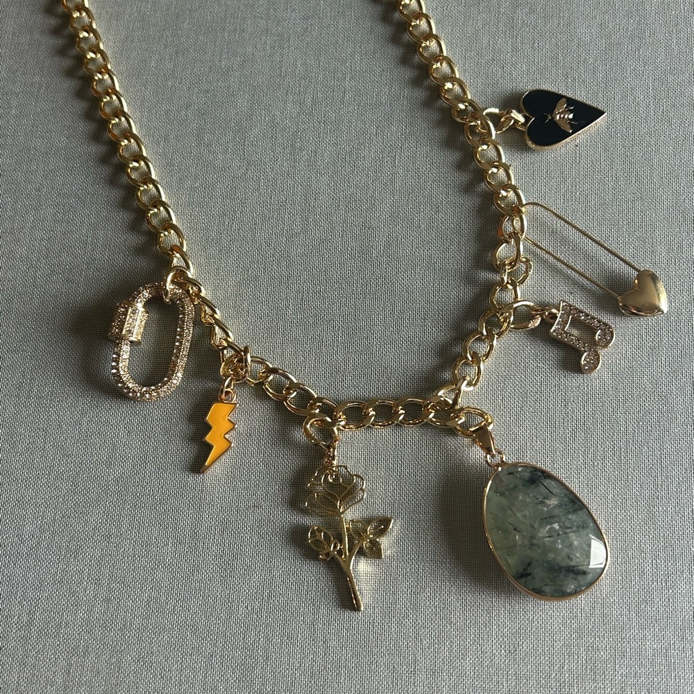 Super cute gold charm necklace. Adjustable length.